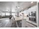 A spacious open-concept kitchen with stainless appliances, granite countertops, and an island with barstool seating at 10849 S 175Th Dr, Goodyear, AZ 85338