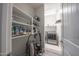 Bright laundry room area with shelving for storage, and a modern washer and dryer at 10849 S 175Th Dr, Goodyear, AZ 85338