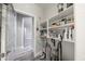 Well-lit and organized laundry and cleaning supply area with shelving, modern flooring, and equipment at 10849 S 175Th Dr, Goodyear, AZ 85338