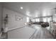 Spacious living room features wood-look flooring, neutral walls, recessed lighting, and contemporary furnishings at 10849 S 175Th Dr, Goodyear, AZ 85338