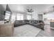 Elegant living room features a modern entertainment center, plush seating, and stylish window treatments at 10849 S 175Th Dr, Goodyear, AZ 85338