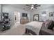 Spacious bedroom featuring a ceiling fan, TV, and an ornate mirror and dresser at 10849 S 175Th Dr, Goodyear, AZ 85338