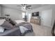 Bright main bedroom features a ceiling fan, television, and an ornate dresser at 10849 S 175Th Dr, Goodyear, AZ 85338