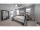 Bright main bedroom boasts a ceiling fan, and a decorative gray accent wall at 10849 S 175Th Dr, Goodyear, AZ 85338