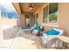 Charming covered patio featuring stylish furniture and a ceiling fan for added comfort at 10849 S 175Th Dr, Goodyear, AZ 85338