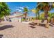 Exterior showing a landscaped backyard with a pool, bench, and grilling area at 11003 E Ravenna Cir, Mesa, AZ 85212