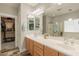 This bathroom boasts double sinks, vanity cabinet storage, a soaking tub, and a glass shower at 11003 E Ravenna Cir, Mesa, AZ 85212