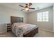 This bedroom features a large bed frame and bed, and a window providing natural light at 11003 E Ravenna Cir, Mesa, AZ 85212