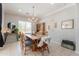 Cozy dining room with an abundance of natural light and hardwood dining set at 11003 E Ravenna Cir, Mesa, AZ 85212