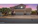 Charming two-story home with three-car garage, tile roof, and desert landscaping at 11003 E Ravenna Cir, Mesa, AZ 85212