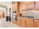 Well-lit kitchen with gas range cooktop, light wood cabinetry, and stainless steel microwave at 11003 E Ravenna Cir, Mesa, AZ 85212
