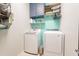 Efficient laundry room with modern washer and dryer, plus ample storage at 11003 E Ravenna Cir, Mesa, AZ 85212