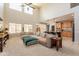 Spacious living room with vaulted ceilings, ceiling fan, and a wall of windows at 11003 E Ravenna Cir, Mesa, AZ 85212
