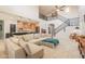 Large open living space with connecting kitchen and staircase featuring neutral tones at 11003 E Ravenna Cir, Mesa, AZ 85212