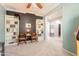 The living room features built-in bookshelves, neutral carpeting, and access to other rooms at 11003 E Ravenna Cir, Mesa, AZ 85212