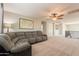 This upstairs loft features neutral carpeting, neutral walls, and a comfortable gray couch at 11003 E Ravenna Cir, Mesa, AZ 85212