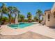 Backyard showcasing a refreshing pool, palm trees, and patio area at 11003 E Ravenna Cir, Mesa, AZ 85212