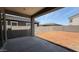 View of a spacious backyard with a covered patio and block fence, ready for landscaping at 11444 E Utopia Ave, Mesa, AZ 85212