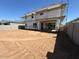 The new home's large, unfinished backyard showing scaffolding on the back side of the home at 11444 E Utopia Ave, Mesa, AZ 85212