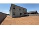 Spacious backyard with block wall, ready for landscaping, with view of covered patio of new home at 11444 E Utopia Ave, Mesa, AZ 85212