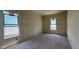 Unfinished bedroom bathed in light from two large windows at 11444 E Utopia Ave, Mesa, AZ 85212