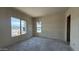 A bright bedroom under construction features drywall walls and two windows offering natural light at 11444 E Utopia Ave, Mesa, AZ 85212