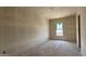 Well-lit, unfinished bedroom with a large window at 11444 E Utopia Ave, Mesa, AZ 85212