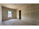 Spacious unfinished bedroom featuring natural light from a window at 11444 E Utopia Ave, Mesa, AZ 85212