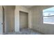 Unfinished bedroom with a walk-in closet and bright window at 11444 E Utopia Ave, Mesa, AZ 85212