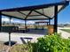 Outdoor gathering area including picnic tables and shelter in the common area of a planned neighborhood at 11444 E Utopia Ave, Mesa, AZ 85212