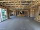 Spacious interior featuring exposed beams, concrete floors, and sliding glass doors at 11444 E Utopia Ave, Mesa, AZ 85212