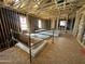 Interior featuring wood framing, exposed beams, and prepped flooring for a new construction at 11444 E Utopia Ave, Mesa, AZ 85212