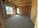 Bright interior featuring exposed beams, concrete floors, and natural light from two windows at 11444 E Utopia Ave, Mesa, AZ 85212