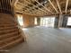 Open interior with exposed beams, staircase, and sliding glass doors leading to the outdoors at 11444 E Utopia Ave, Mesa, AZ 85212