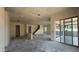Living room under construction features drywall walls, a staircase, and sliding glass doors to the outdoors at 11444 E Utopia Ave, Mesa, AZ 85212
