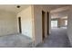 An unfinished living room shows open doorway frames, smooth concrete floors, and a great view to the outside at 11444 E Utopia Ave, Mesa, AZ 85212