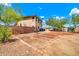 Large backyard featuring garden beds, block wall, and desert landscaping under a bright sky at 12709 N El Frio St, El Mirage, AZ 85335