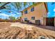 Spacious backyard features a stone patio, barbecue grill, and desert landscaping under a bright sky at 12709 N El Frio St, El Mirage, AZ 85335
