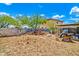 Unkempt backyard featuring dirt, debris, and a cinderblock wall under a bright sky at 12709 N El Frio St, El Mirage, AZ 85335