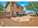 Spacious backyard with a stone patio, barbecue grill, and desert landscaping under a bright sky at 12709 N El Frio St, El Mirage, AZ 85335