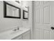 Clean and bright standard bathroom with a sink, a mirror and white walls at 12709 N El Frio St, El Mirage, AZ 85335