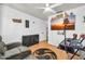 Cozy bedroom with reclining seats, a large TV, a ceiling fan, and modern decor at 12709 N El Frio St, El Mirage, AZ 85335