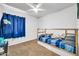 Bright bedroom featuring a ceiling fan and a daybed, perfect for relaxation at 12709 N El Frio St, El Mirage, AZ 85335