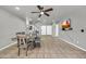 Open floor plan with a dining area, modern table set, and an adjacent staircase at 12709 N El Frio St, El Mirage, AZ 85335