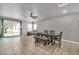 Large dining area with wood floors, ceiling fan, and a sliding door that provides outdoor access at 12709 N El Frio St, El Mirage, AZ 85335