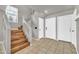 Entryway featuring tiled floors, wooden stairs with white rails, and two white doors at 12709 N El Frio St, El Mirage, AZ 85335