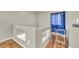 Indoor upstairs hallway with baby gate, banister, and wood flooring at 12709 N El Frio St, El Mirage, AZ 85335