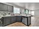 Modern kitchen with a window over sink, stainless steel dishwasher, and bar seating at 12709 N El Frio St, El Mirage, AZ 85335