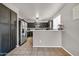 Open concept kitchen with stainless steel appliances and large breakfast bar at 12709 N El Frio St, El Mirage, AZ 85335