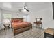 Comfortable main bedroom featuring a large bed, ceiling fan, and natural light at 12709 N El Frio St, El Mirage, AZ 85335